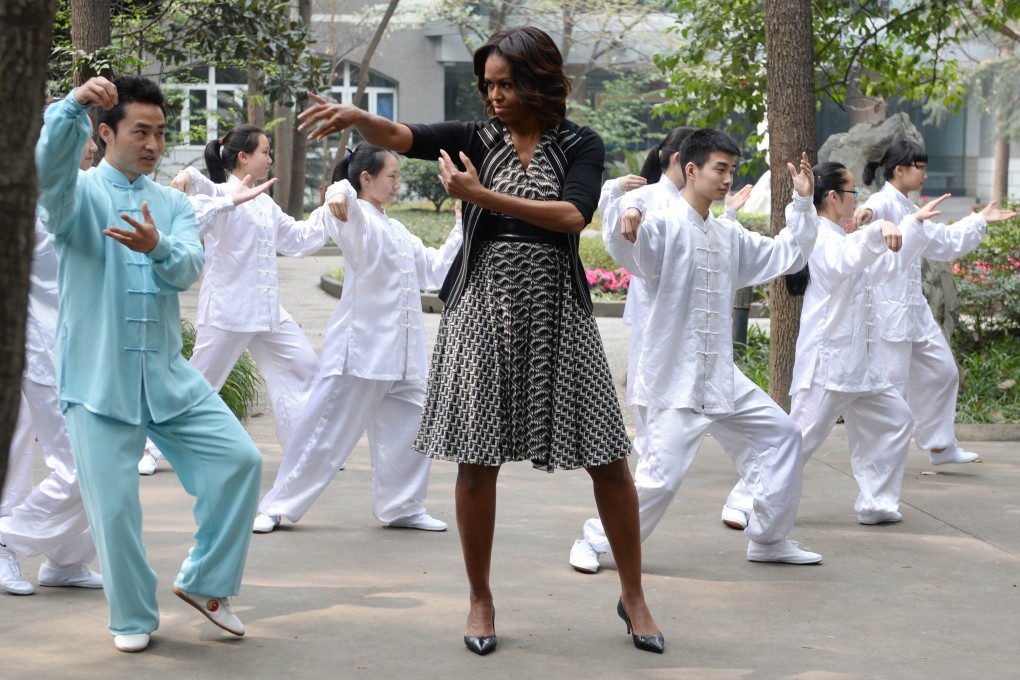 US First Lady Michelle Obama performs "tai chi" with students from the Chengdu No7 High School in Chengdu in China's southwest Sichuan province on March 25, 2014. Photo: AFP