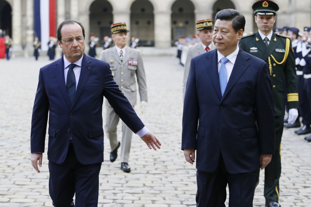 Francois Hollande and Xi Jinping at a ceremony in Paris yesterday. Xi is on a four-nation tour of Europe. Photo: AFP