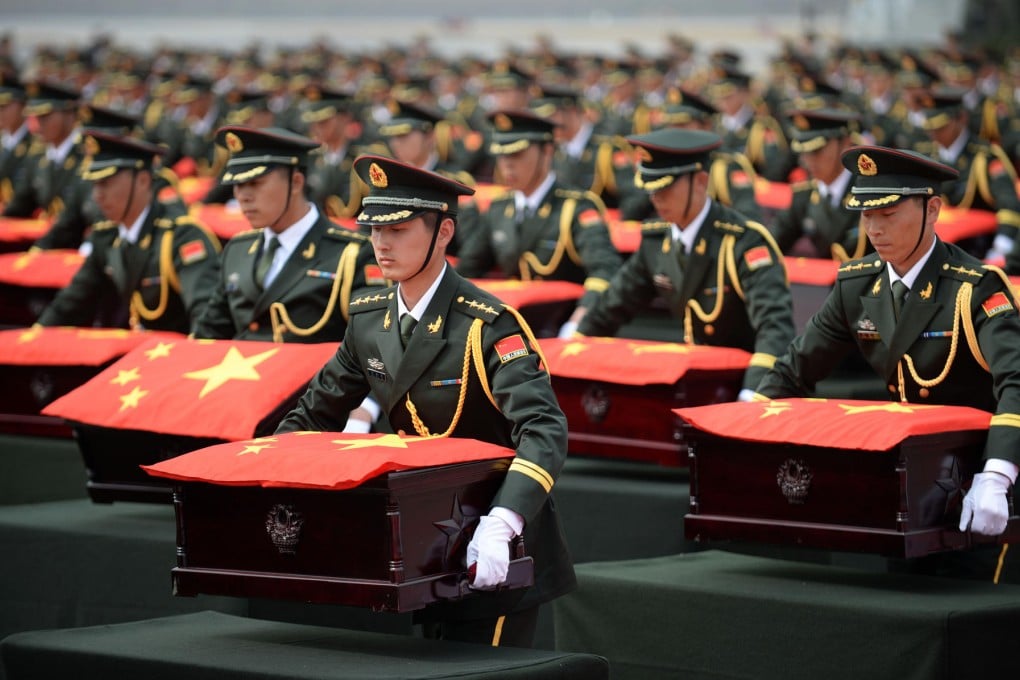 People's Liberation Army soldiers accept caskets containing the remains yesterday. Photo: Xinhua