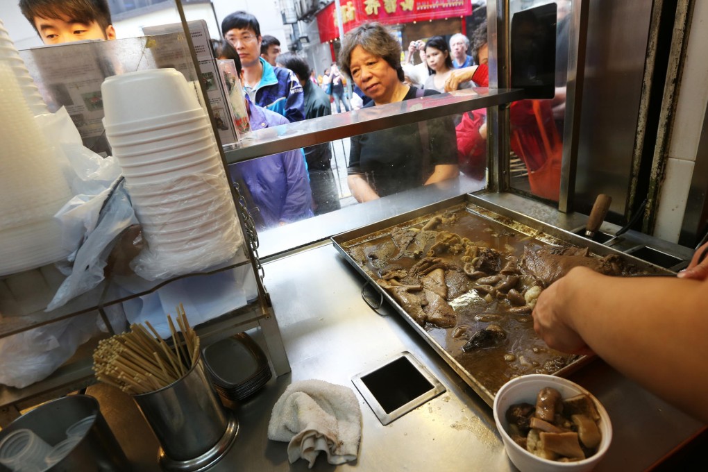 Loyal customers wait in line on the Block 13 Beef Offal shop's last day of operation after eight years yesterday. Photo: David Wong