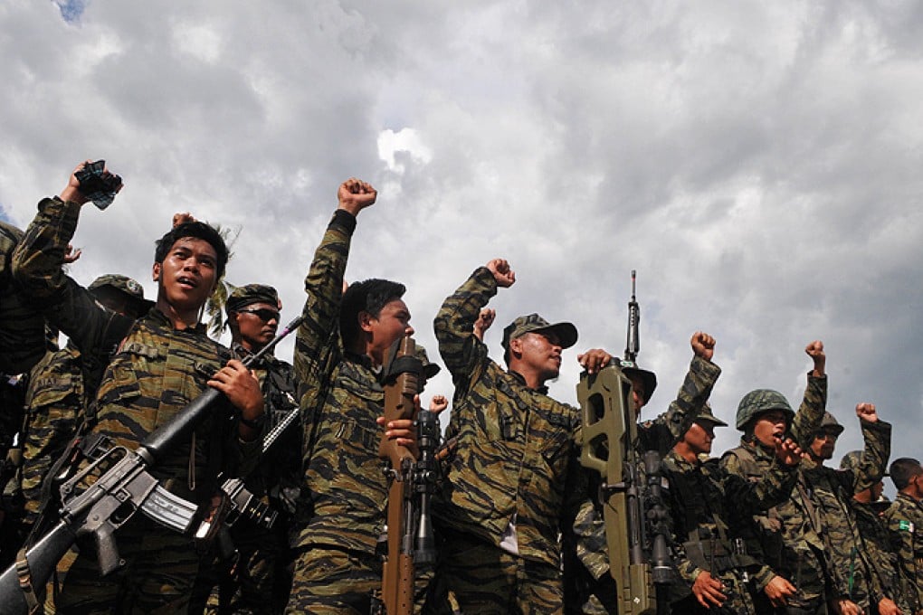 Moro Islamic Liberation Front members celebrate the signing of a peace accord between the government and their group. Photo: Associated Press