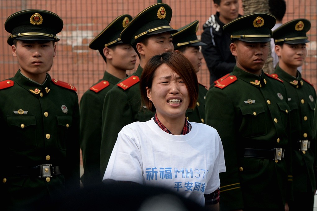 A grieving relative of a Chinese passenger on missing flight outside the Malaysian embassy in Beijing. Photo: SCMP Pictures