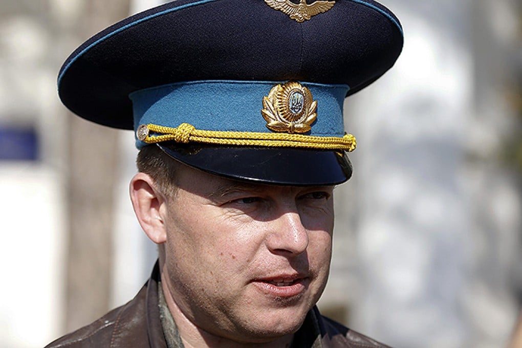 Colonel Yuliy Mamchur, the commander of a Ukrainian air base, speaks to the media in the Crimean town of Belbek near Sevastopol. Photo: Reuters
