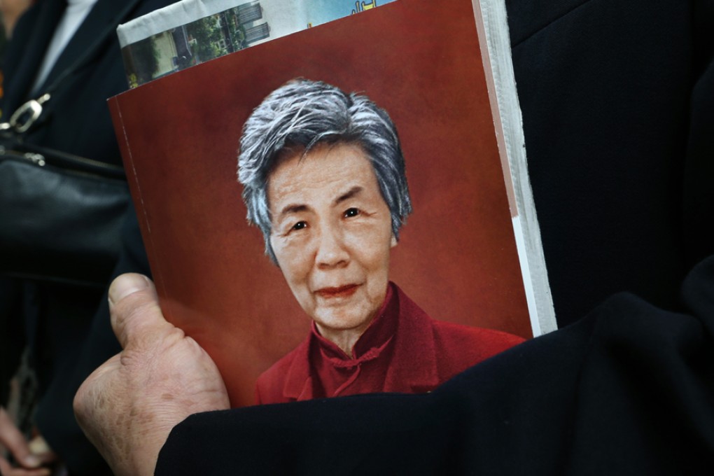 A mourner holds an image of Chung Chi-yung, co-founder of Shue Yan University, during her funeral at the Hong Kong Funeral Home in North Point. Photo: Edward Wong