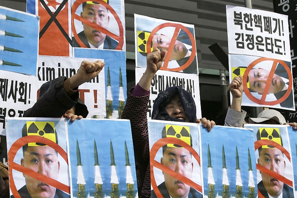 South Korean activists burn disfigured portraits of North Korean leader Kim Jong-un during a rally in Seoul. Photo: EPA