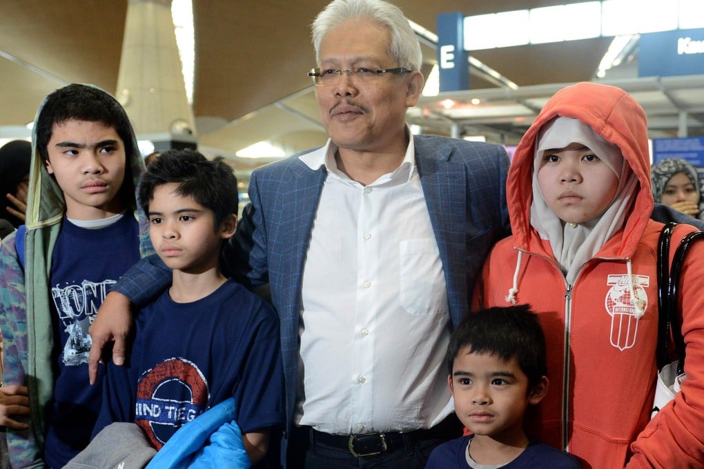 Azizul Awalludin (centre), 38, and his wife Shalwati Norshal, 46, were sentenced by a Stockholm court to 10 and 14 months respectively for beating their children, aged seven to 14, over a three-year period with a bamboo stick, a clothes hanger and their hands. Photo: AFP