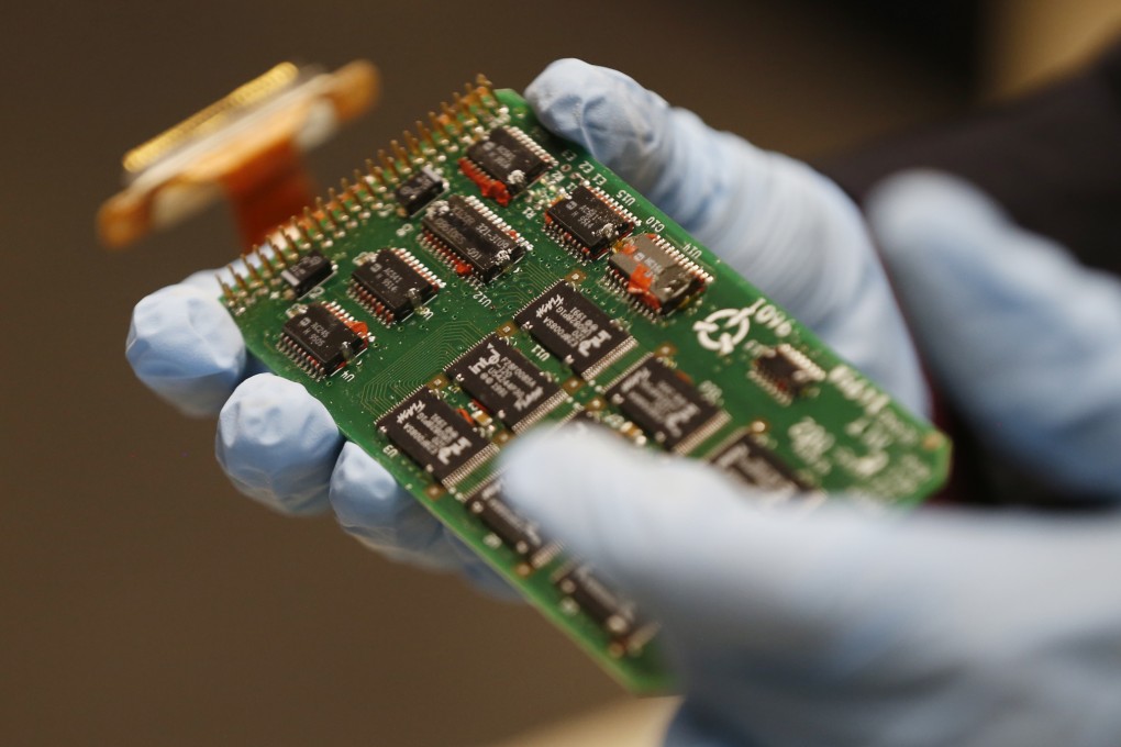 Erin Gormley, aerospace engineer at the National Transportation Safety Board (NTSB), shows the chips where the data from a flight recorder is stored during a news media tour of the NTSB Vehicle Recorder Laboratory in Washington on Friday.Photo: AP