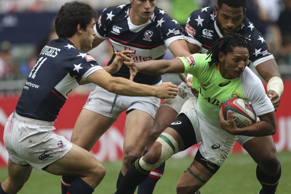 South Africa's Justin Geduld is overwhelmed by the USA defence during their Plate semi-final on Sunday. Photo: Felix Wong