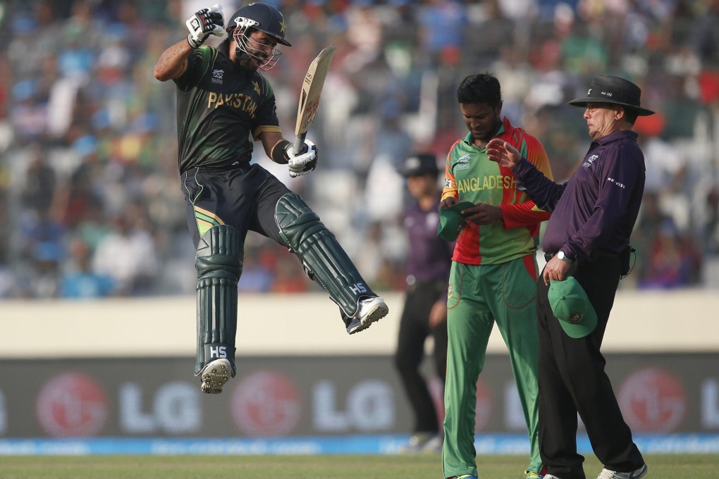 Pakistan batsman Ahmed Shehzad leaps in the air after reaching his century in the Twenty20 match against Bangladesh in Dhaka. Photo: AP