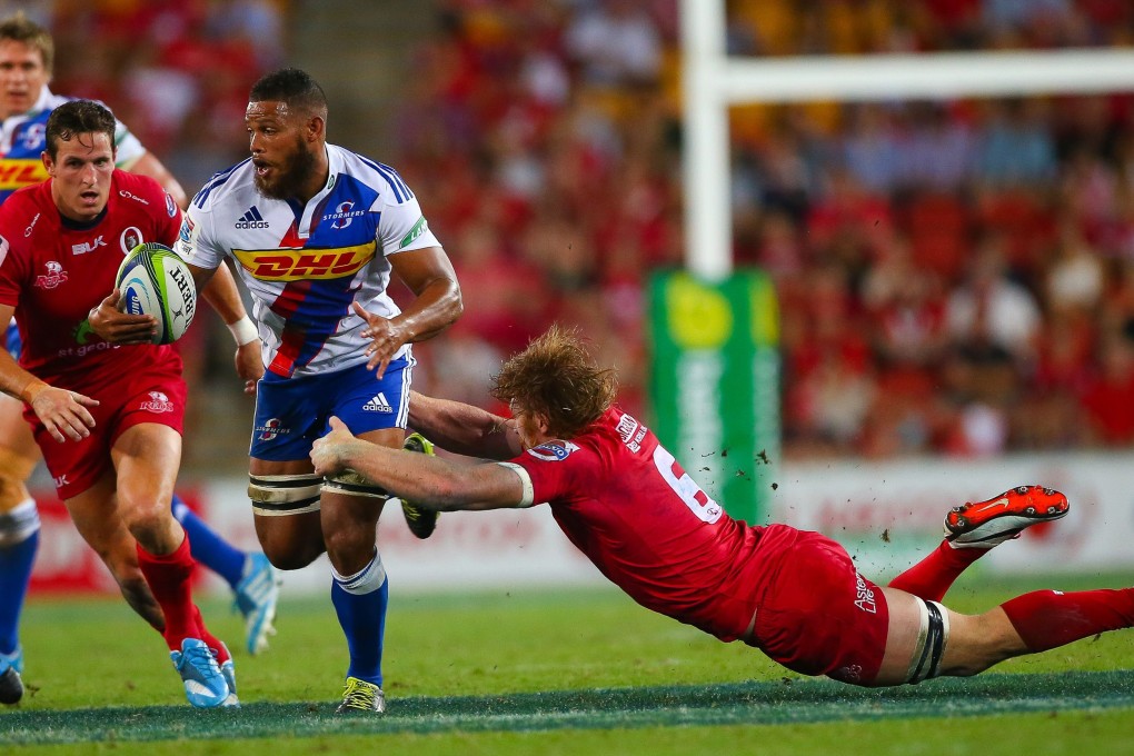 Stormers flanker Nizaam Carr is tackled by Reds flanker Ed Quirk during their Super 15 match at Suncorp Stadium in Brisbane. Photo: AFP