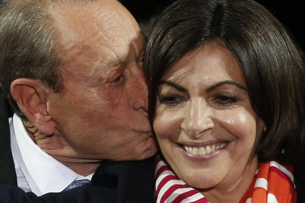 Spanish-born Anne Hidalgo celebrates with outgoing Paris mayor Bertrand Delanoe at the Paris town hall. Photo: Reuters