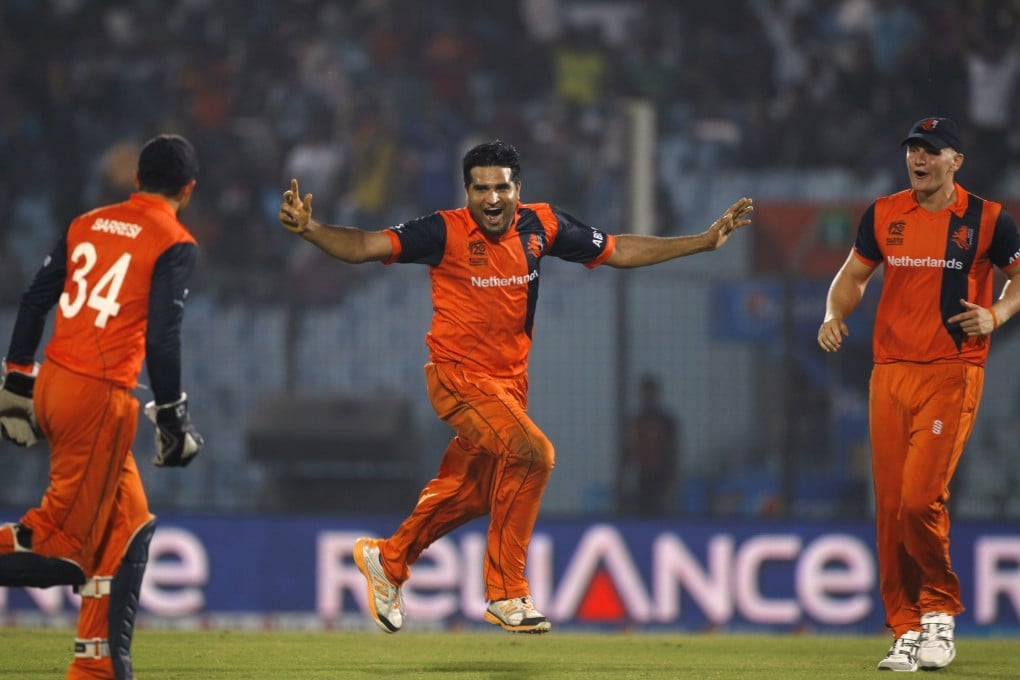 Netherlands' Mudassar Bukhari, centre, celebrates with teammates after taking the wicket of England's captain Stuart Broad. Photo: AP
