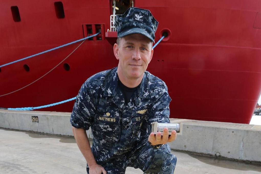 US Navy Captain Mark Matthews holds an acoustic pinge. Photo: AFP
