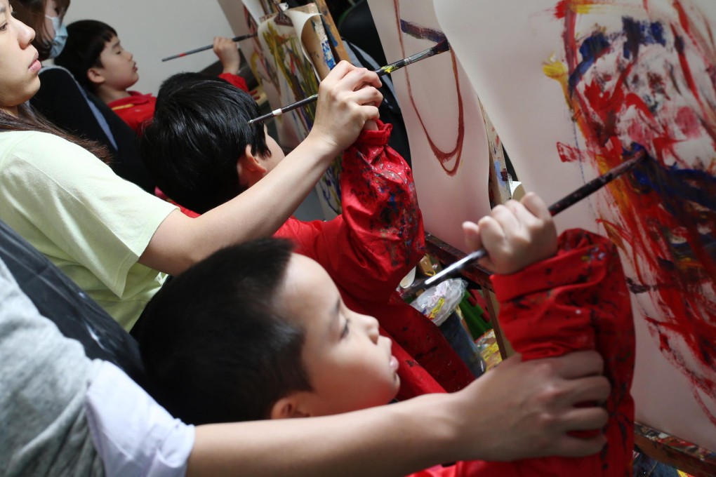 Children paint to the beat of music at the Children's Institute in Kennedy Town. Photo: K. Y. Cheng