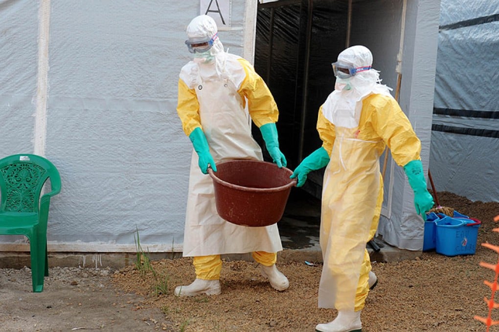 Health specialists work in an isolation ward for Ebola patients at the Doctors Without Borders facility in Guinea. Photo: AFP