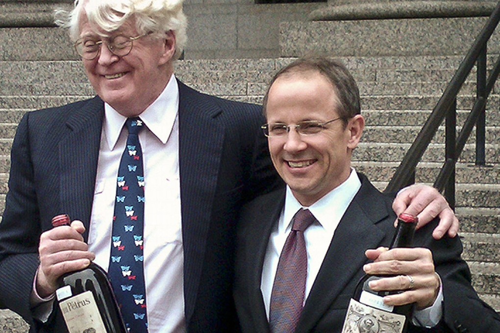 Florida billionaire William Koch, left, and his lawyer John Hueston hold bottles of wine outside Manhattan federal court. Photo: AP