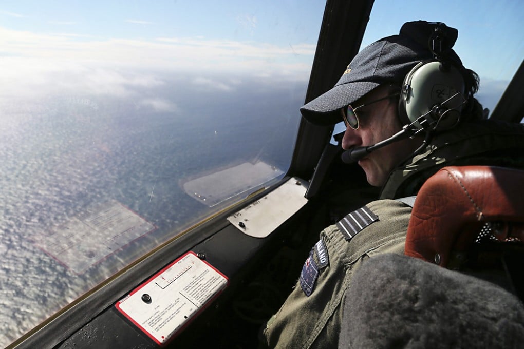 A Royal New Zealand Air Force captain searches for missing Malaysia Airlines Flight MH370 off Perth, Australia on March 31, 2014. Photo: EPA