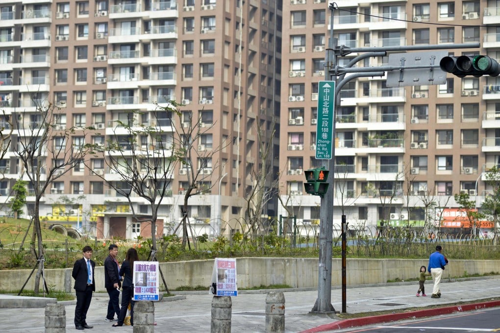 Property agents scout for customers at an intersection in Danshui, once a sleepy north coast town that has become a new model for urban development. Photo: Chris Stowers
