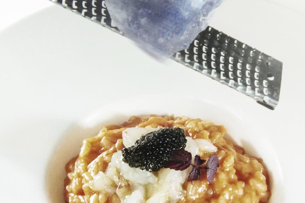 Persian blue salt is grated over red prawn risotto with malossol caviar at Aqua Armani.