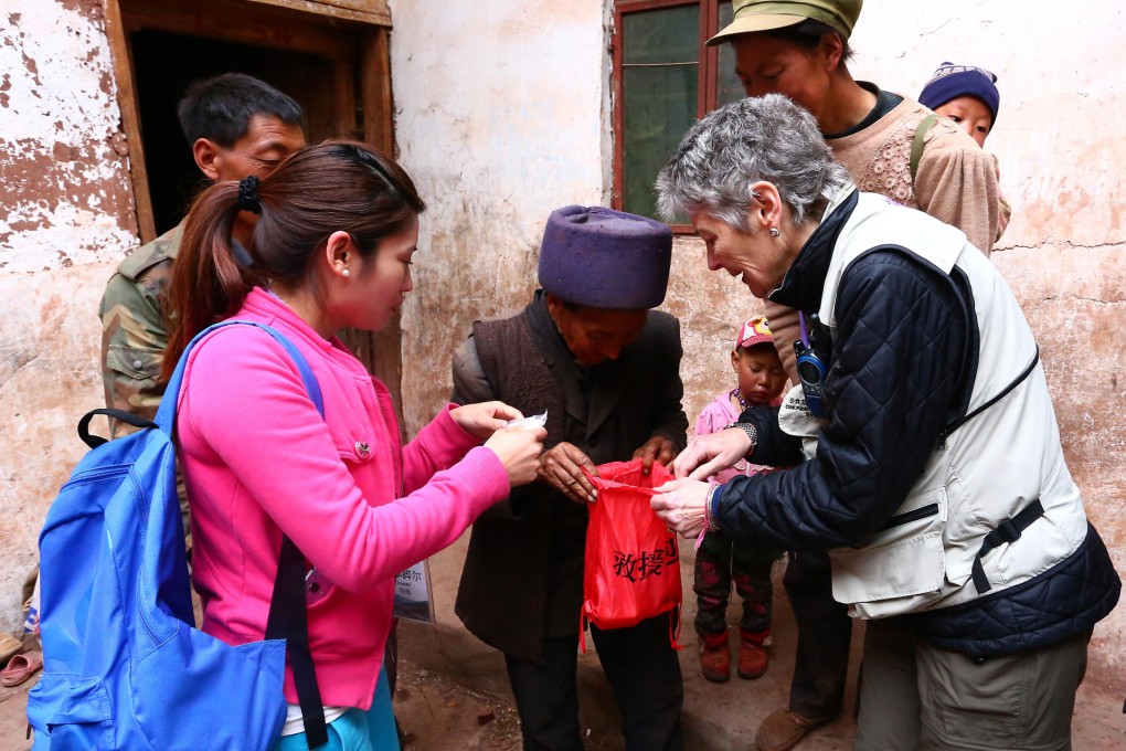 Professor Jennifer Leaning, right, gives a disaster relief bag to a villager in the flood-prone village of Hongyan in Sichuan. Photo: CUHK