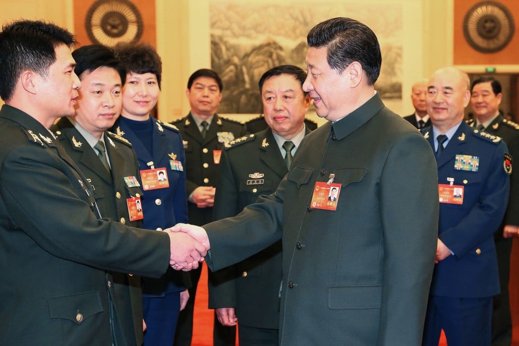 Chinese President Xi Jinping talks with a deputy to the 12th National People's Congress (NPC) from the People's Liberation Army (PLA) in Beijing on March 11. Photo: Xinhua