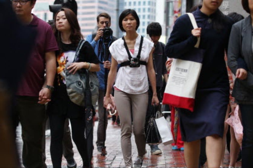 Post reporter Ada Lee (centre) walks from her home in Taikoo Shing to the office in Causeway Bay. Photo: Nora Tam