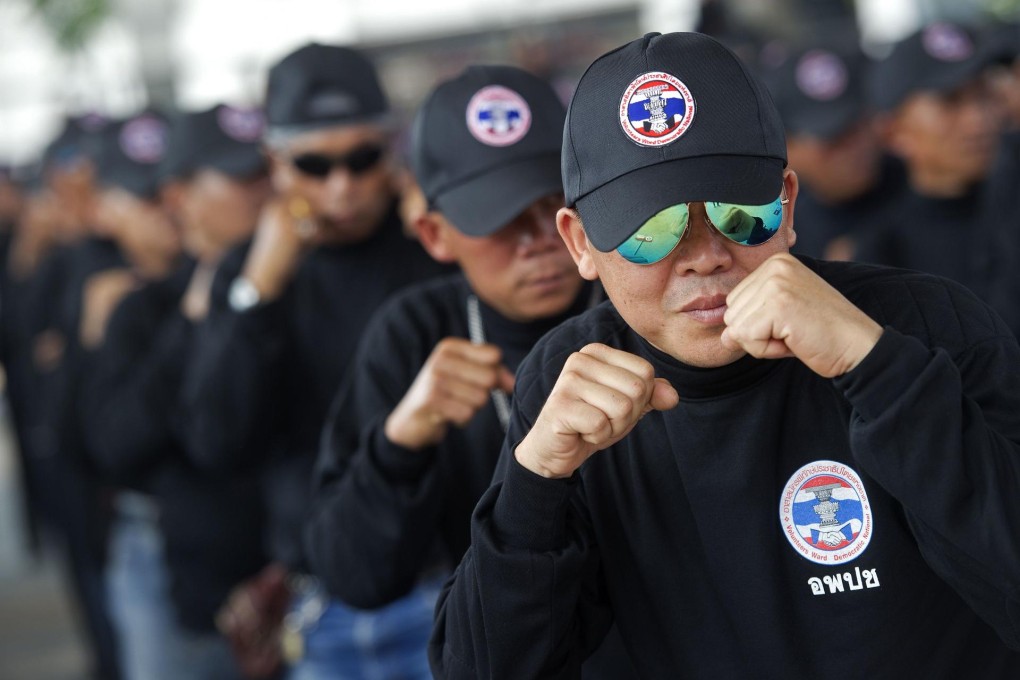 Black-clad "red shirt" supporters practise self-defence at a "Democracy Protection Volunteers" camp in northeast Thailand. Photo: AFP