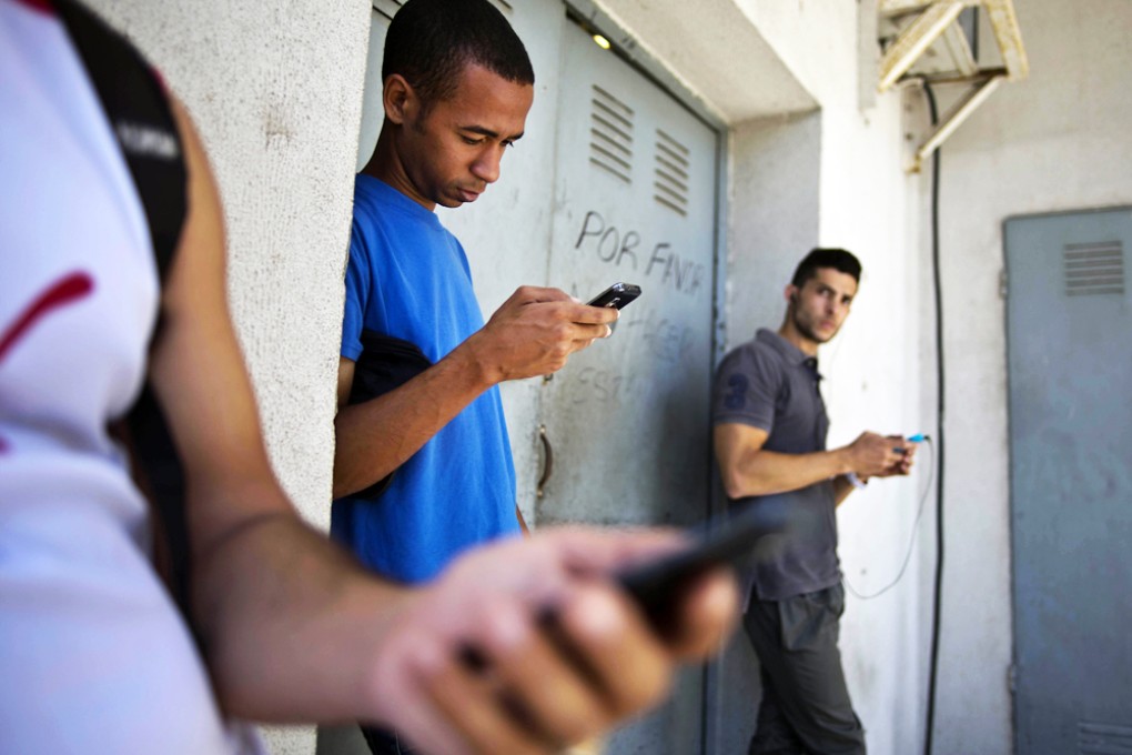Students use their smart phones in Havana, Cuba. Photo: AP