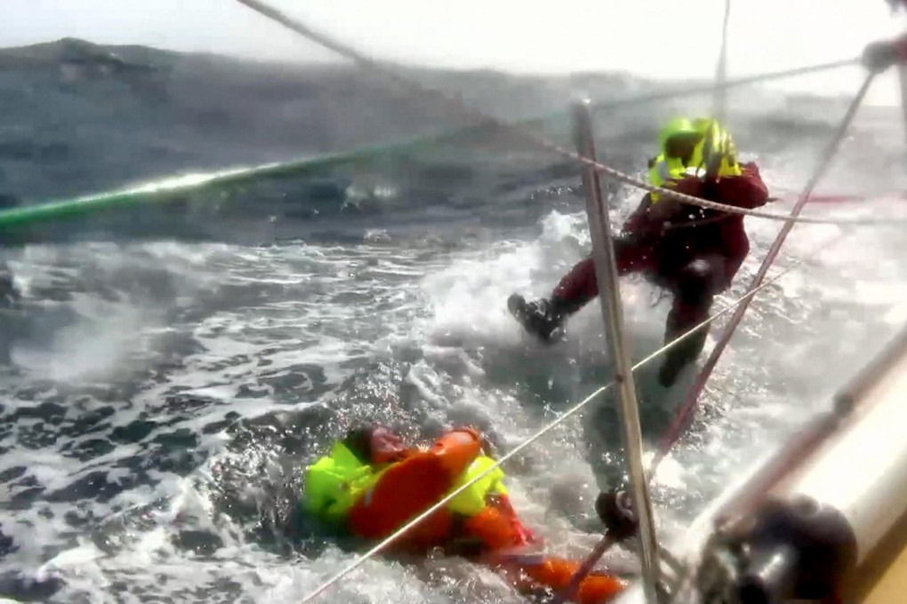 Andrew Taylor is about to be pulled out of the cold North Pacific waters by one of his crewmates after he was thrown overboard. Photo: AP