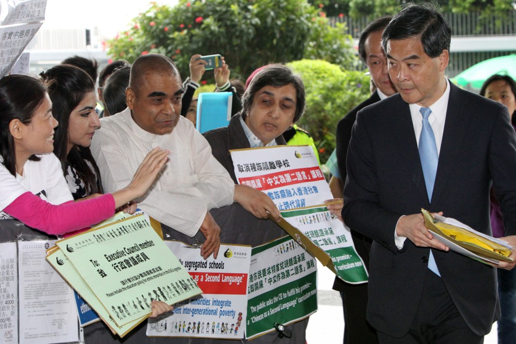 Executive Director of Hong Kong Unison Fermi Wong (left) leads a group of ethnic minorities to submit a petition letter to Chief Executive Leung Chun-ying to address their education needs on Nov. 12, 2013. Photo: SCMP/Felix Wong