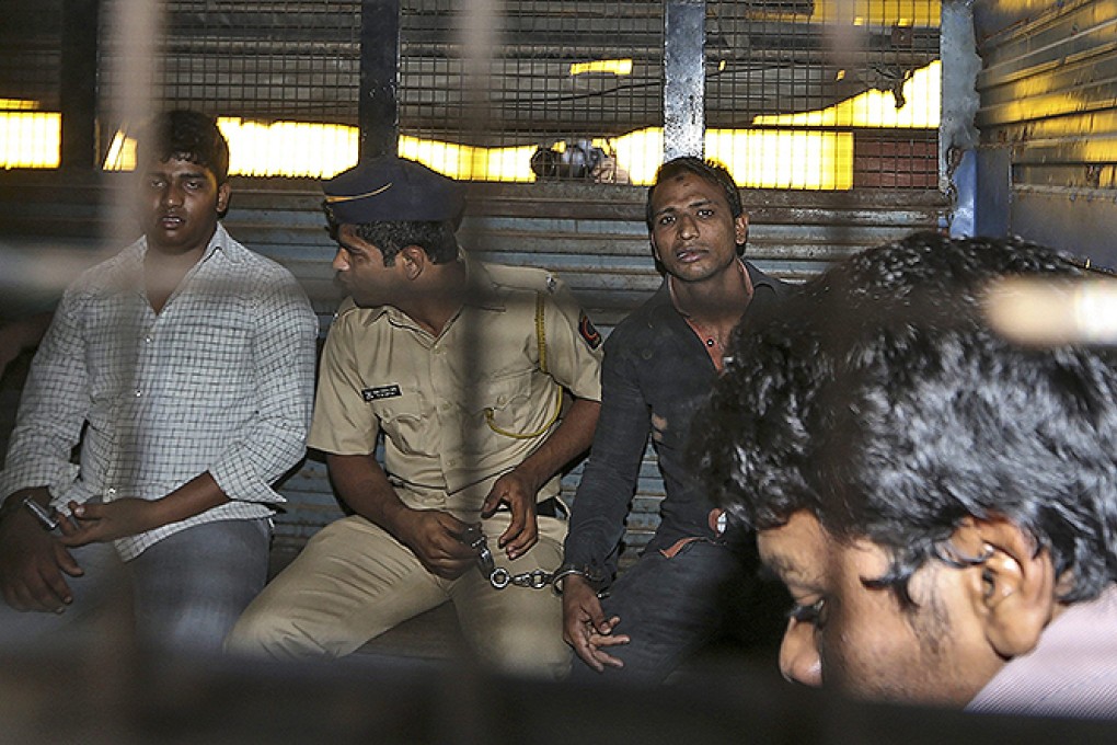 The three Shakti mill rape defendants are escorted by police to a court hearing in Mumbai. Photo: EPA