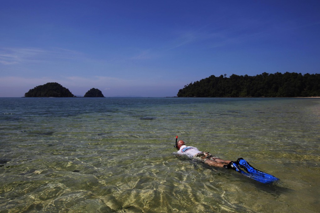A tourist snorkels in Lampi National Park. The marine park has until recently been considered one of Myanmar's many 'paper parks' - areas officially protected but basically uncared for. Photo: AP