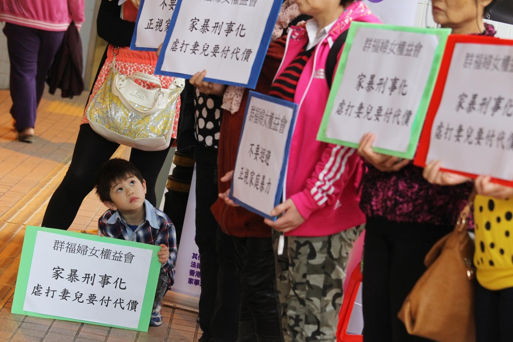 Women and children stand in silence to mark 10 years since the killing of Kim Shuk-ying and her children in Tin Shui Wai. Photo: Dickson Lee