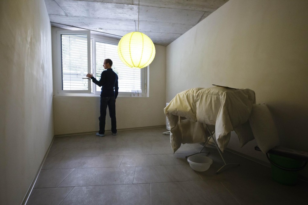 A resident stands inside one of the purpose built apartments. The residents suffer from Multiple Chemical Sensitivity. Photos: AFP