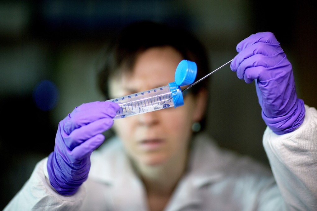 Microbiologist Dr. Molly Freeman pulling bacteria from a tube to be tested for its DNA fingerprinting in a foodborne disease outbreak lab at the federal Centers for Disease Control and Prevention in Atlanta. Photo: AP