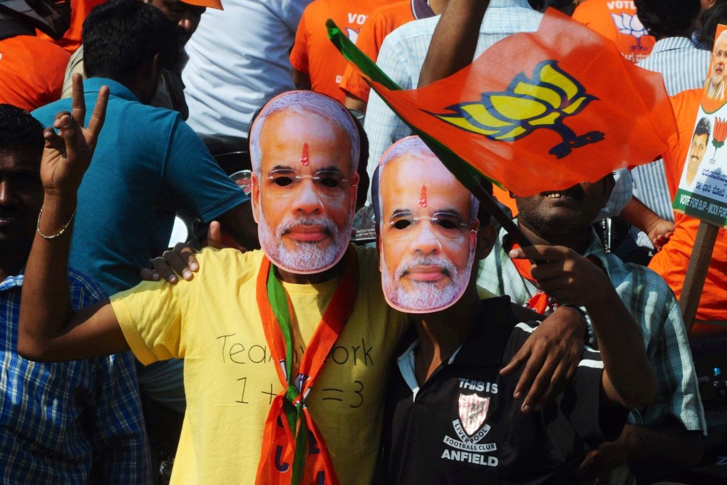 Supporters of the Bharatiya Janata Party wear masks of prime ministerial candidate Narendra Modi during a campaign rally in Bangalore, India, for the Lok Sabha elections, which started today. Photo: EPA