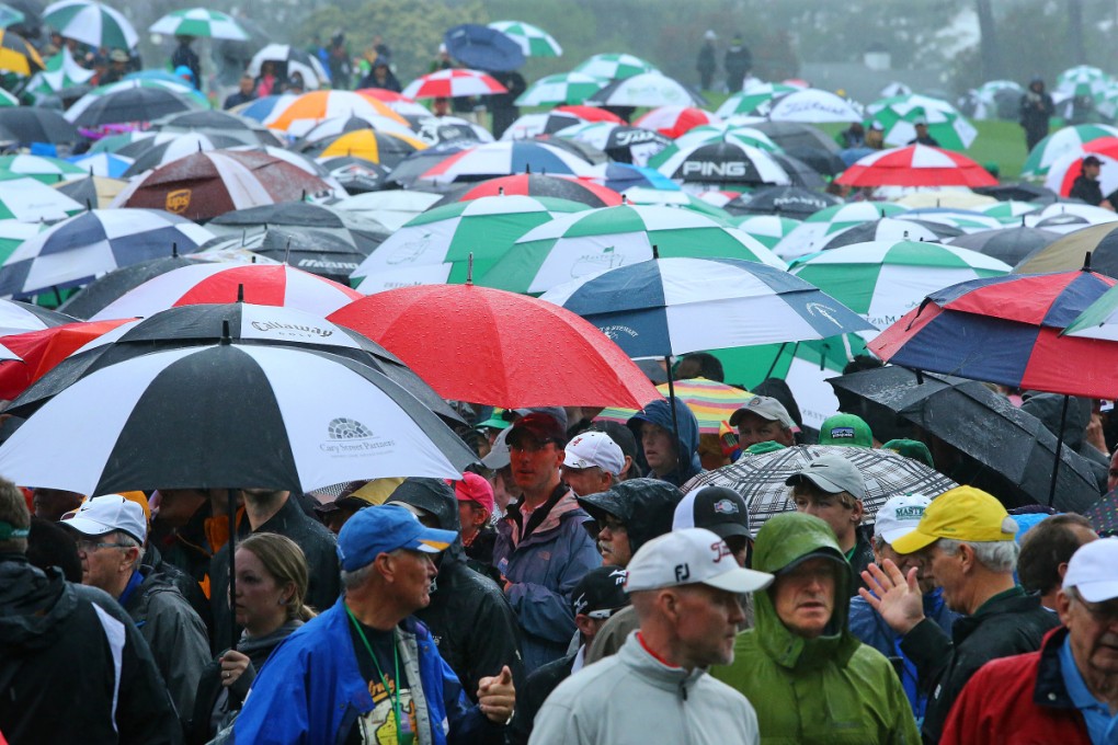 Masters fans leave Augusta National Golf Club in Augusta, Ga., Monday, April 7, 2014. Storms moved into the area just two hours after the gates opened at Augusta National. Photo: AP