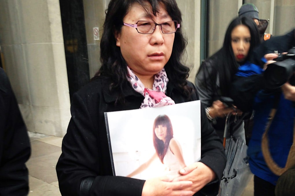 Zheng Yaru holds a photo of her daughter Qian Liu outside a courthouse in Toronto. Photo: AP