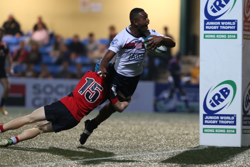 Outside centre Nemia Qoro scores one of his two tries in the second half, despite a valiant tackle by Hong Kong's Hugo Stiles, as the United States ran out convincing 37-0 winners on the opening day of the IRB Junior World Rugby Trophy at HKFC. Photos: K.Y Cheng