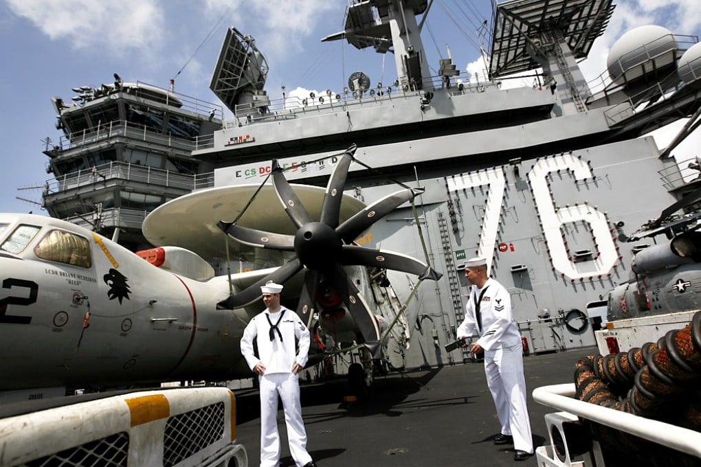 Sailors standing guard on the flight deck of carrier USS Ronald Reagan. Photo: Jonathan Wong