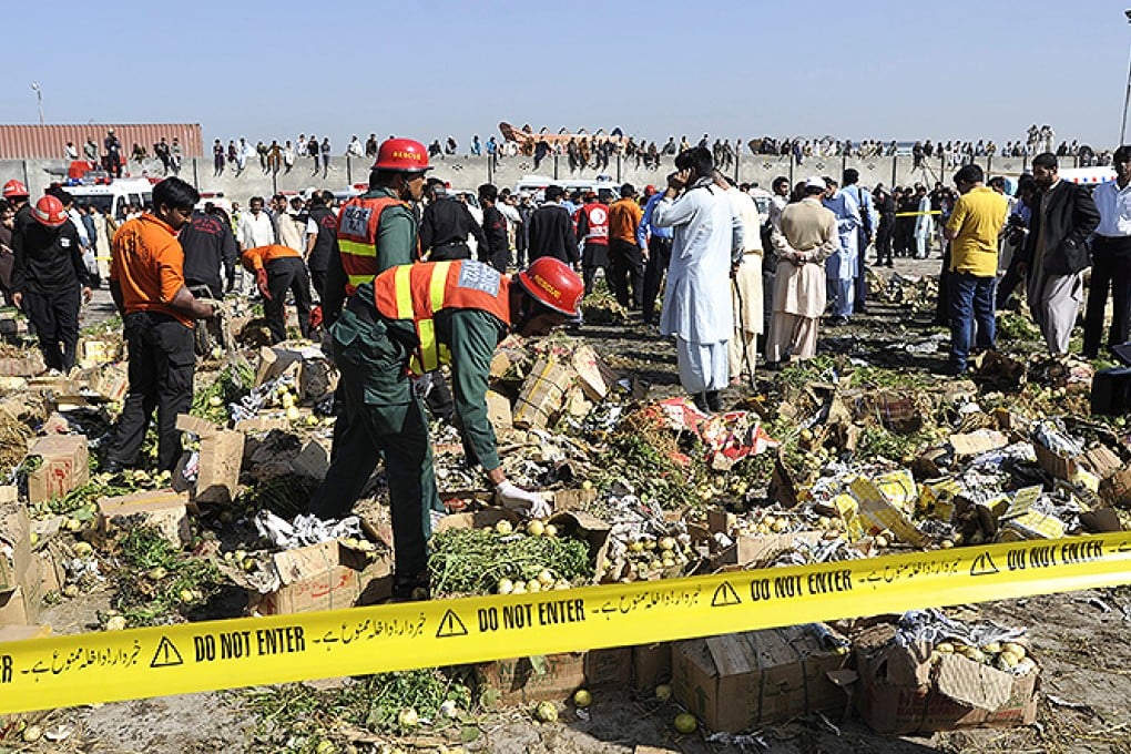 Pakistani security officials and rescue workers inspect the scene of a bomb blast that targeted a grocery market in Islamabad. Photo: EPA