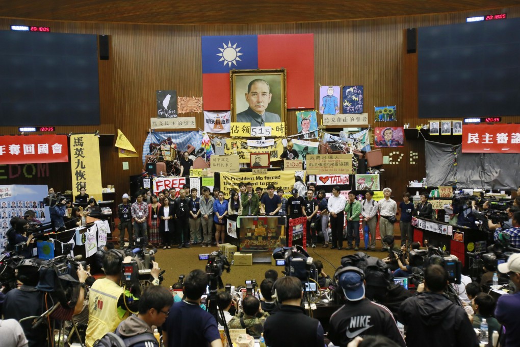 Student protestering against a trade pact with China hold a press conference on the legislature floor in Taipei. Photo: AP