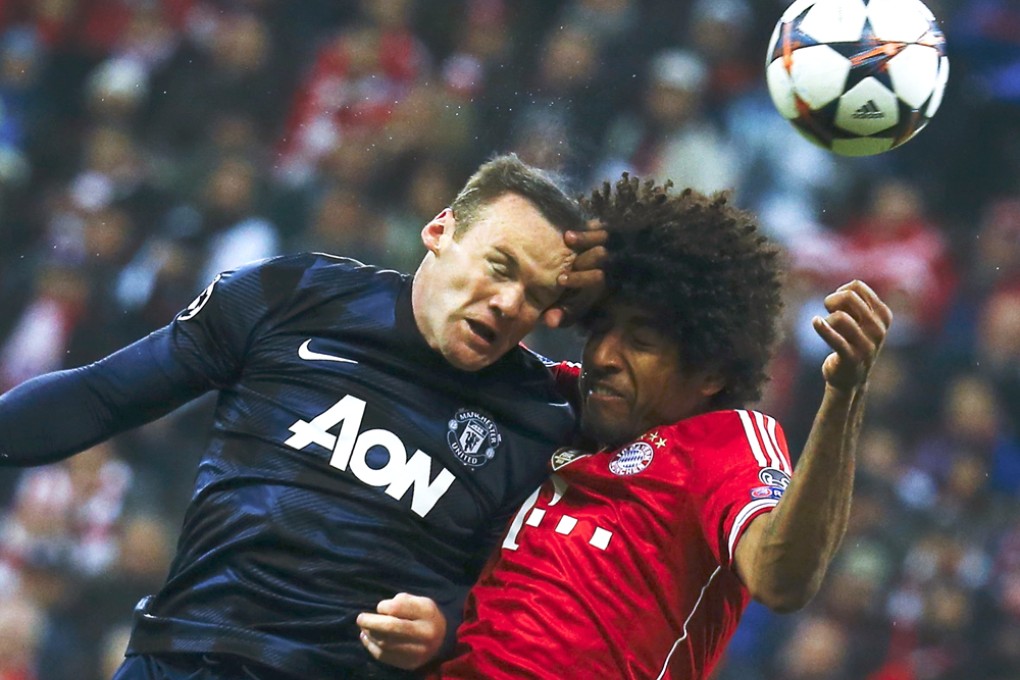 Wayne Rooney goes for a header with Bayern Munich's Dante. Photo: Reuters