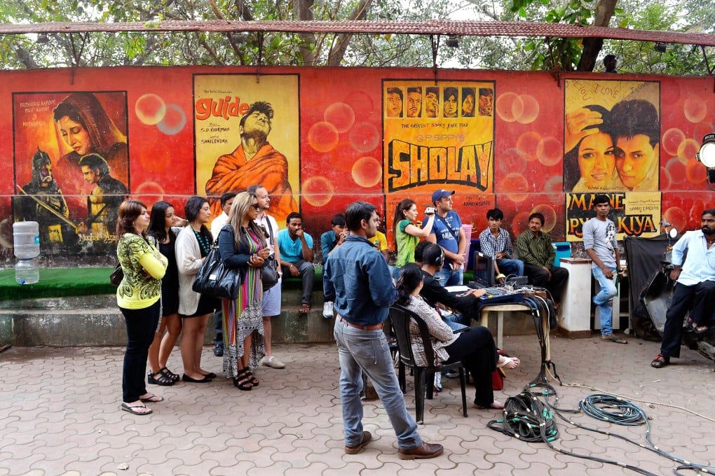Tourists watch a shoot on a Bollwood film set in Mumbai. Photo: AFP