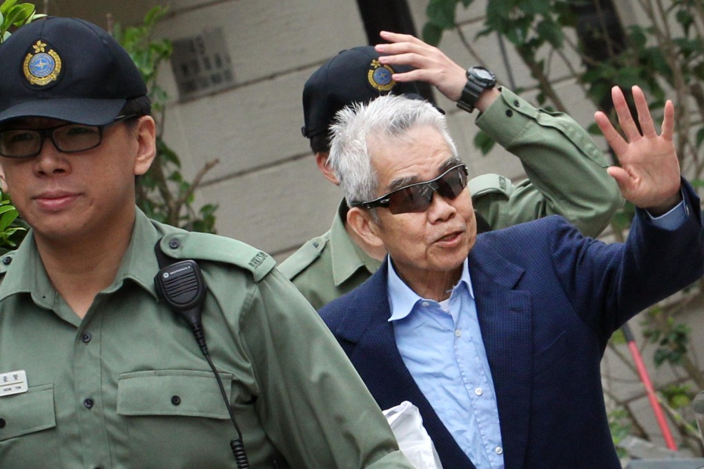 A grey-haired Brian Kan waves as he leaves Stanley Prison yesterday morning. He spent a total of nine months behind bars. Photo: Felix Wong