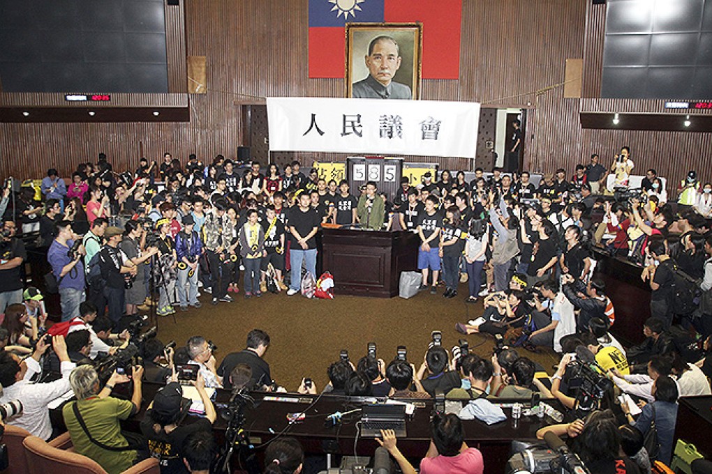 Student protesters demonstrating against a trade pact with China hold a press conference on the legislature floor in Taipei. Photo: AP