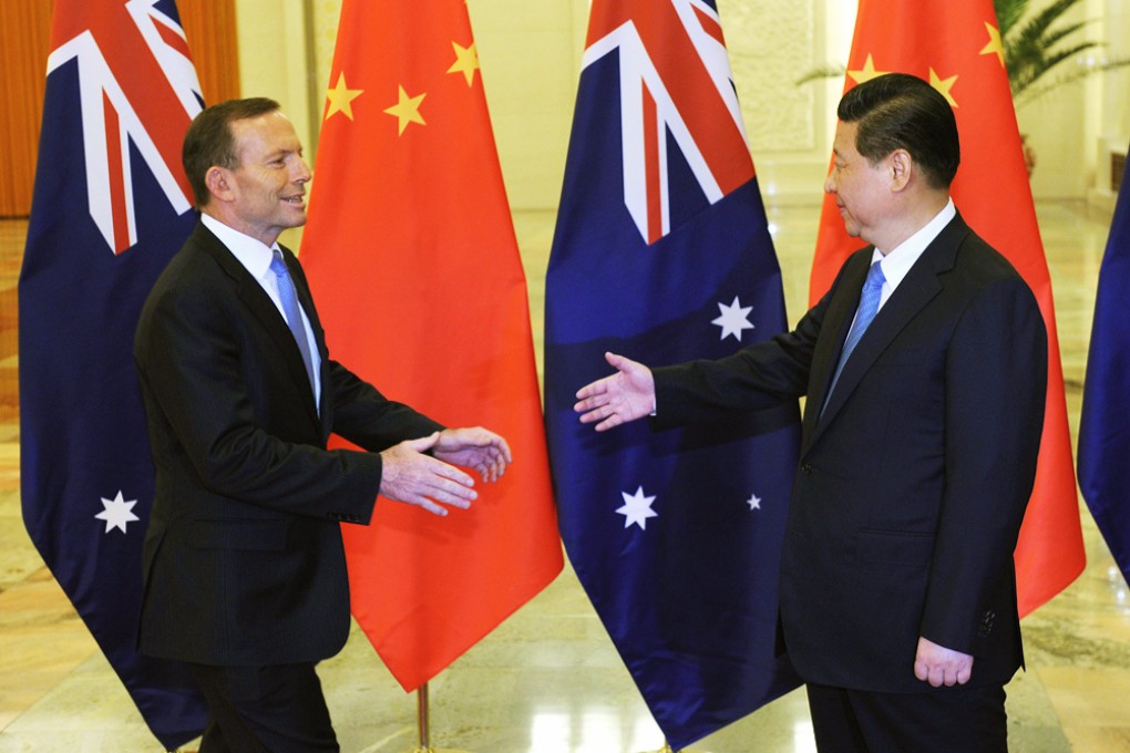 Chinese President Xi Jinping (right) extends his hand to greet Australian Prime Minister Tony Abbott before a meeting at the Great Hall of the People in Beijing on April 11, 2014. Photo: Reuters