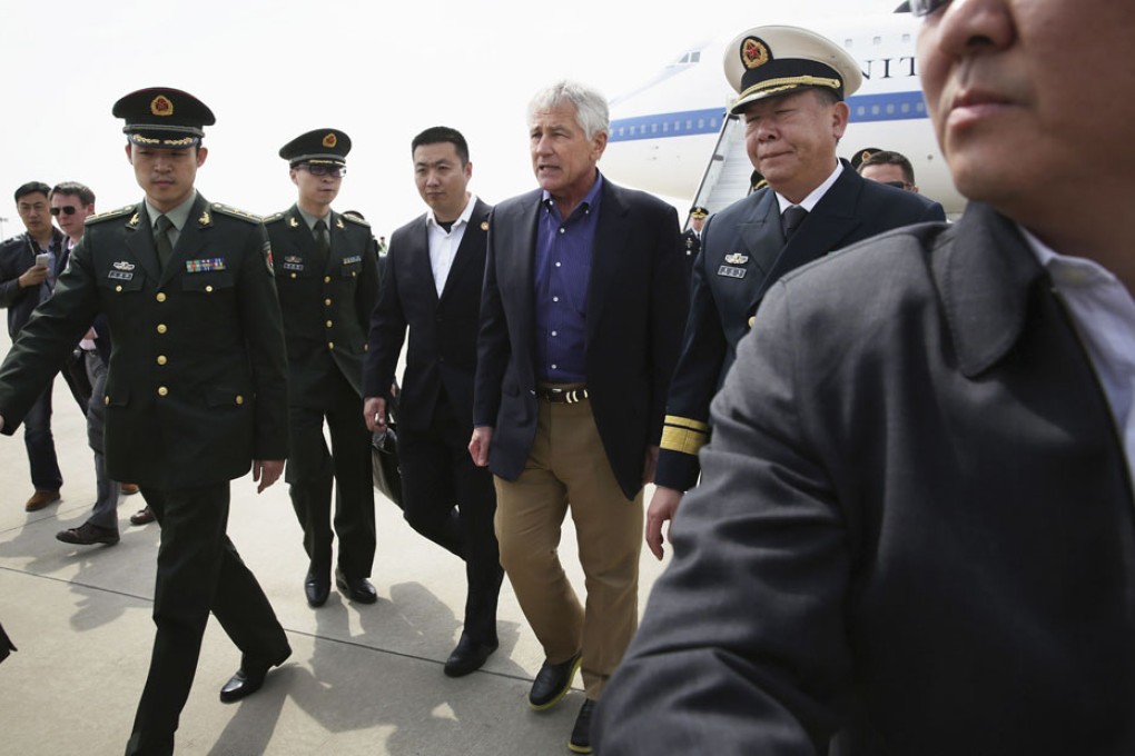 US defence chief Chuck Hagel is greeted by military personnel as he arrives at Qingdao airport before his inspection of China's first aircraft carrier, the Liaoning. Photo: AP