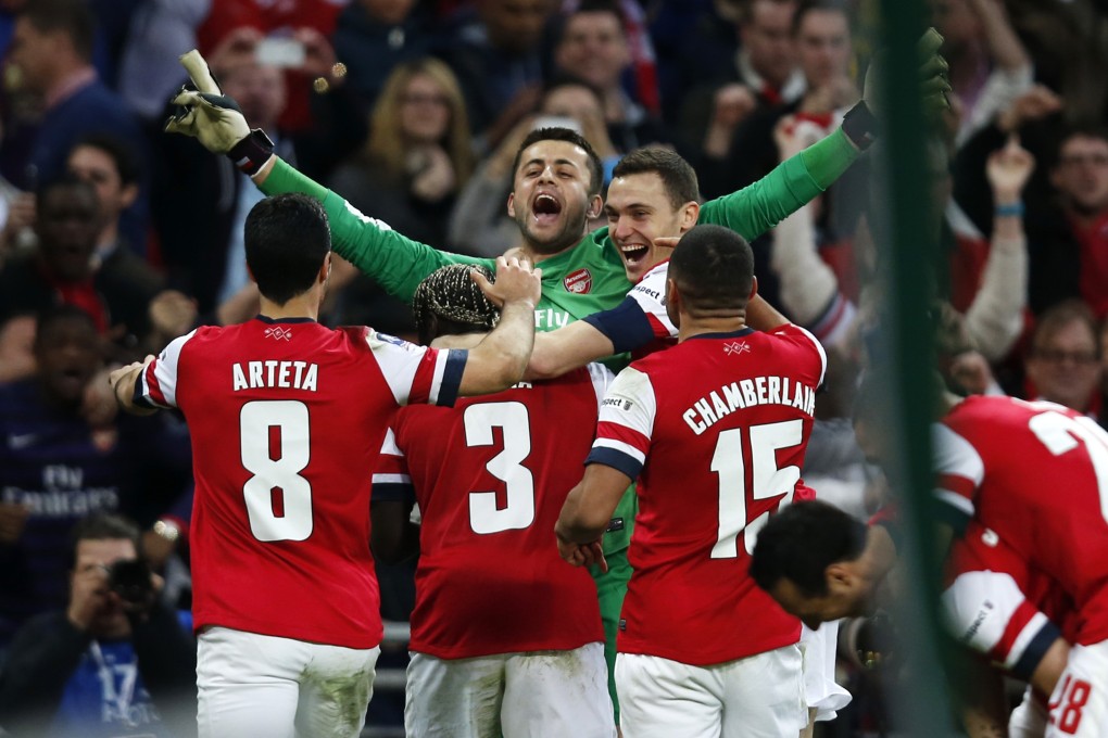 Arsenal goalkeeper Lukasz Fabianski celebrates with teammates after the penalty shoot-out win. Photo: Xinhua