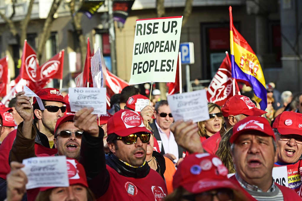 Protestors hold banners and flyers during a demonstration in Madrid. European Trade Union Confederation calls for more demonstrations with the participation of twenty trade unions from twelve European countries. Photo: AFP